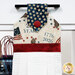 A close up shot of the top of the hanging towel, showing details on the patriotic fabrics.