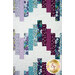 A close up on the lavender, plum purple, and teal blue jelly roll zig zags on the Ridiculously Easy Jelly Roll Quilt. 
