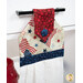 A close up on the top of the towel, demonstrating fabric colors and button closure detail.