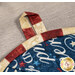 A super close up shot on the fabric loop of the hot pad, demonstrating stitching and binding details.