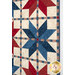 A closer look at the patchwork of the quilt, demonstrating fabric prints and color details as well as top quilting effects.