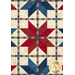 A head-on close up of the quilt, demonstrating fabric prints and color details as well as top quilting effects.