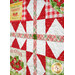 An angled close up of the quilt, demonstrating top quilting effects over the patchwork.