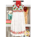 The completed Hanging Towel colored in aqua and red fabrics from the Berry Besties collection by Henry Glass Fabrics, hung on a white kitchen drawer and staged with coordinating décor.