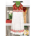 The completed Hanging Towel colored in green and red fabrics from the Berry Besties collection by Henry Glass Fabrics, hung on a white kitchen drawer and staged with coordinating décor.