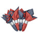 Four folded napkins in red and blue patterns with silver bands, isolated on a white background. 