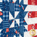 An angled close up on the blue and white fabrics, showing print colors and details.