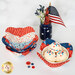 Patriotic bowl cozies with ice cream and sprinkles, alongside a flower vase and decorative jars.