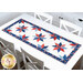 The completed Floating Stars Runner, staged on a white table.