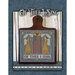 Mounted cross stitch project of two angels beside an American flag, with the text "Of Thee I Sing."