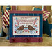 Framed needlepoint project featuring the Pledge of Allegiance, flanked by an eagle, flowers, and flags.