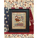 Framed needlepoint featuring an eagle, the text In God We Trust, and a flag design.