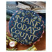 Image of the finished round project with the pattern title and designer logo.