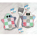 Two of the ghostly hot pads in fabrics from the A Cat Named Stitch collection, staged with a spatula.
