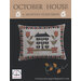 A decorative cross sitch pillow featuring a house design, surrounded by flowers and geometric patterns.