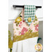 A close up shot of the top of the hanging towel, showing details on the floral prints and fabric button.