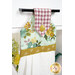 A close up shot of the top of the hanging towel, showing details on the floral prints and fabric button.