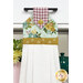 A close up shot of the top of the hanging towel, showing details on the floral prints and fabric button.
