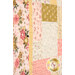 A close up on the patchwork of the quilt, demonstrating fabric color and print details as well as top quilting effects.