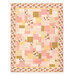 The completed Easy as ABC and 123 Quilt Kit colored in pink, cream, and ocher fabrics from the Renew collection by Riley Blake Designs, isolated on a white background. 