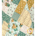 A close up on the patchwork of the quilt, demonstrating fabric color and print details as well as top quilting effects.