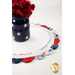 A shot of the topper staged with a patriotic vase and red flowers.