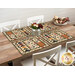 The completed Quail Run placemats, set on a wooden table with rustic décor. 