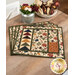 The completed Quail Run placemats, slightly fanned out, staged on a wooden table with rustic flowers. 