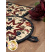 A close up of the edge of the round hot pad, showing the binding as well as the fabric loop.
