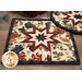 A super close up on the center of the square hot pad, demonstrating the cream fabric details on the beautiful folded star center.