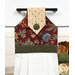 A close up shot of the top of the hanging towel, showing details on the floral prints and fabric button.