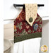 A close up shot of the top of the hanging towel, showing details on the button closure.