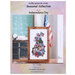 Front cover of pattern showing the completed project, framed and staged in a classroom.