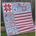The completed quilt in vibrant red, white, and blue fabrics.