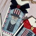 A close up on the stitched Uncle Sam design, surrounded by red and blue elements and a bow.