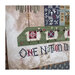 A super close up on the house, showing stitching details on the sheep and text.