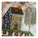A super close up on the house, showing stitching details on the house and tree.