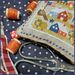 A close up on the finished Patriotic Tiny Village, showing stitching details.