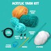 Contents of the kit featuring acrylic yarn balls, a crochet hook, safety eyes, a needle, and stuffing.