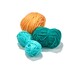 A shot of the yarn balls on a white background, showing color details.