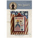 Miss Liberty pattern cover featuring a the finished cross-stitch staged with americana decor.