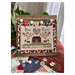 Image of the completed cross stitch featuring a red colonial house, sheep, florals, and the words "God Bless America"