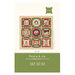 Front of the pattern showing the completed quilt design featuring patchwork and panel fabrics from the Holiday Cheer collection.