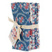 A bundle of Village Life fabric from Tilda isolated on a white background. 