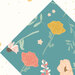 Closeup of the cream floral cheater fabric on a dark teal block with a medley of florals.