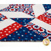 A close up on the detailed patchwork on the table topper. 
