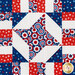 A top down shot of the center 4-pointed star demonstrating fabric designs and top stitching. 