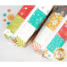 A top down shot of the two Mini-Charm Bags, showing fabric and color details, staged with coordinating buttons.