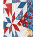 An angled shot of the quilt showing patchwork details as well as topstitching effects. 