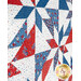 An angled shot of the quilt showing patchwork details as well as topstitching effects. 